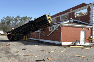 A school bus was thrown onto the roof of the former Winterboro High School building in Talladega County, Ala. during this weekend's severe weather. Credit: Courtesy of NWS Birmingham