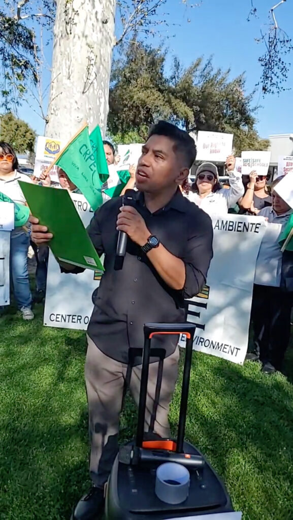 Angel Garcia, co-director of Californians for Pesticide Reform, speaks outside an event in Shafter, Calif., celebrating the launch of a statewide pesticide notification system.