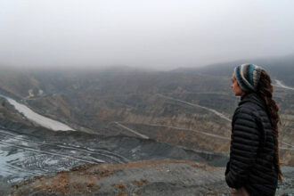 Carola Rackete looks into the Majdanpek copper mine in East Serbia. The mine, run by the Chinese company Zijin, has been linked to large scale pollution, river alteration and deficient environmental impact studies. Credit: Courtesy of Carola Rackete
