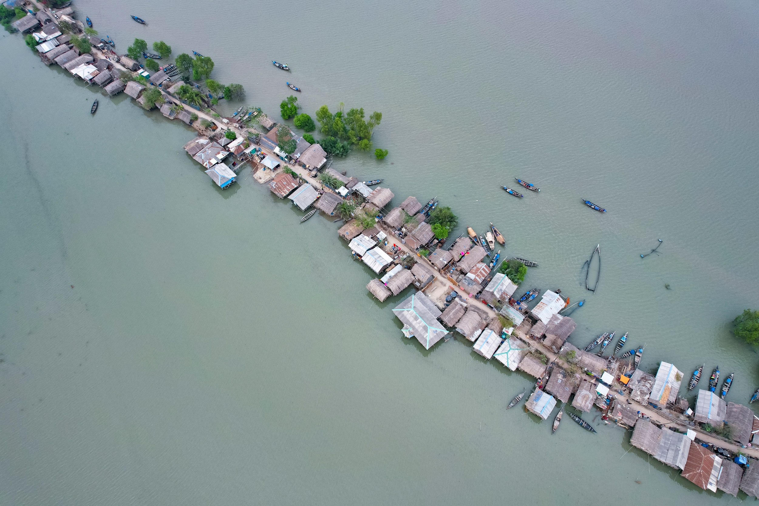 An aerial view of the Kalabogi village in Khulna, Bangladesh during the high tide on March 10, 2023. The village has been facing frequent cyclones and floods since the late 1990s. Credit: Kazi Salahuddin/NurPhoto via Getty Images