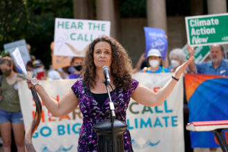 Rabbi Jennie Rosenn, founder and CEO of Dayenu, speaks at a Jewish climate action event in New York City on Sept. 12, 2021. Credit: Jemal Countess/Getty Images for Green New Deal Network