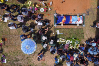 People attend the burial of indigenous environmental activist Quinto Inuma Alvarado, leader of the Kichwa community in remote Peru, on Dec. 2, 2023. Credit: Christian Sierra/AFP via Getty Images