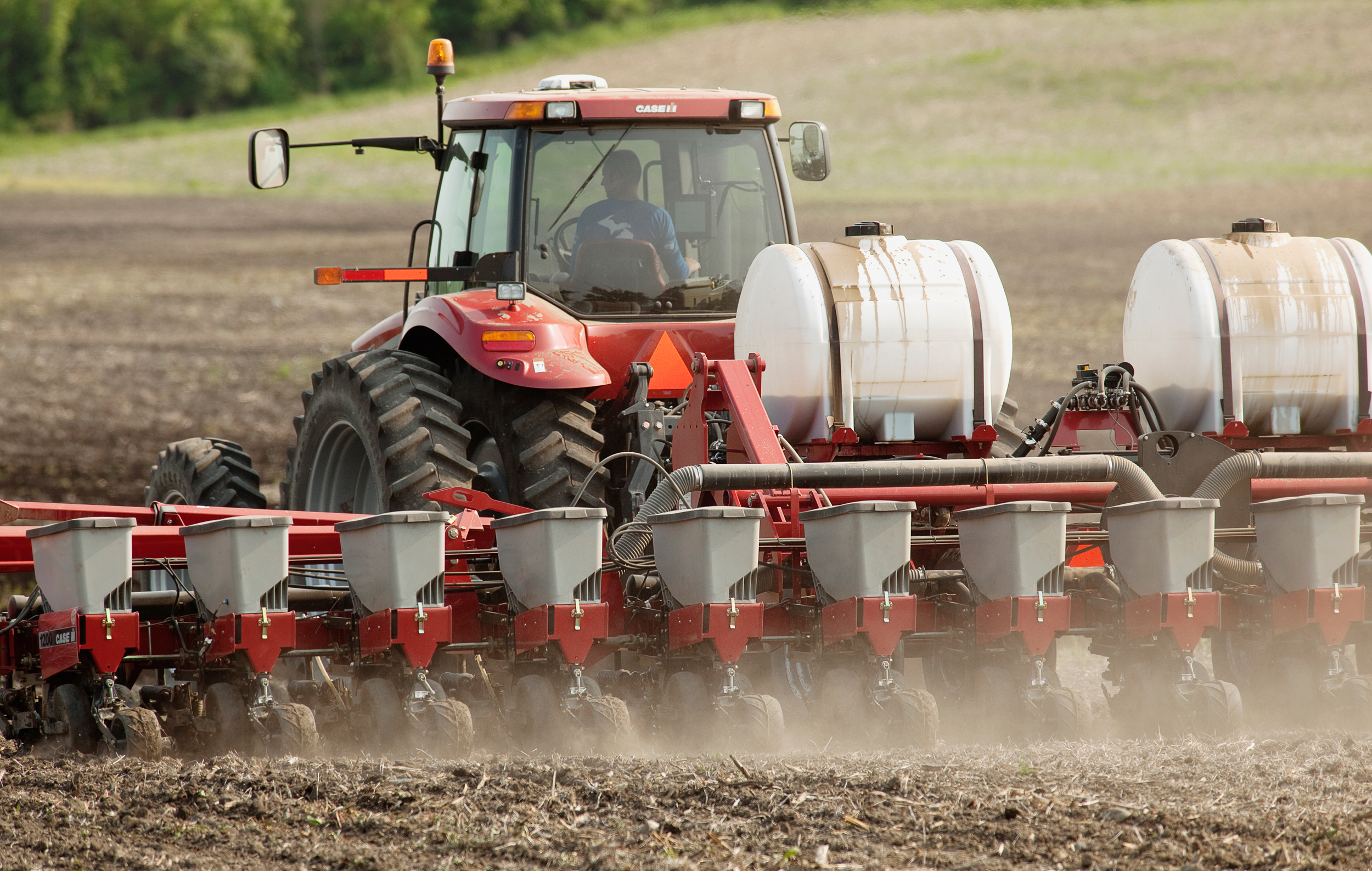 A farmer plants corn using a Case IH tractor and 16-row planter assisted by an on board computer that monitors and controls seed and fertilizer application. Credit: Andrew Sacks/Design Pics Editorial/Universal Images Group via Getty Images