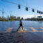 A person walks through a flooded street from the rising Anclote River as the region tries to recover from Hurricane Milton on Oct. 11, 2024, in New Port Richey, Fla. Credit: Spencer Platt/Getty Images
