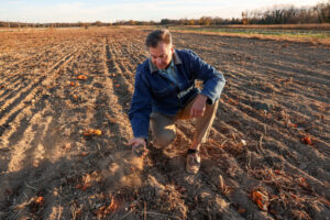 Al Krupski, owner of Krupski Farms in Peconic, N.Y., holds dry soil in one of his pumpkin fields on Nov. 19, 2024, as Long Island undergoes a three-month drought. Credit: Steve Pfost/Newsday RM via Getty Images