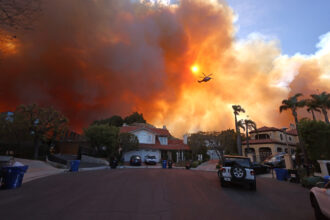 Plumes of smoke fill the sky as a brush fire burns on Jan. 7 in Pacific Palisades, Calif. Credit: David Swanson/AFP via Getty Images