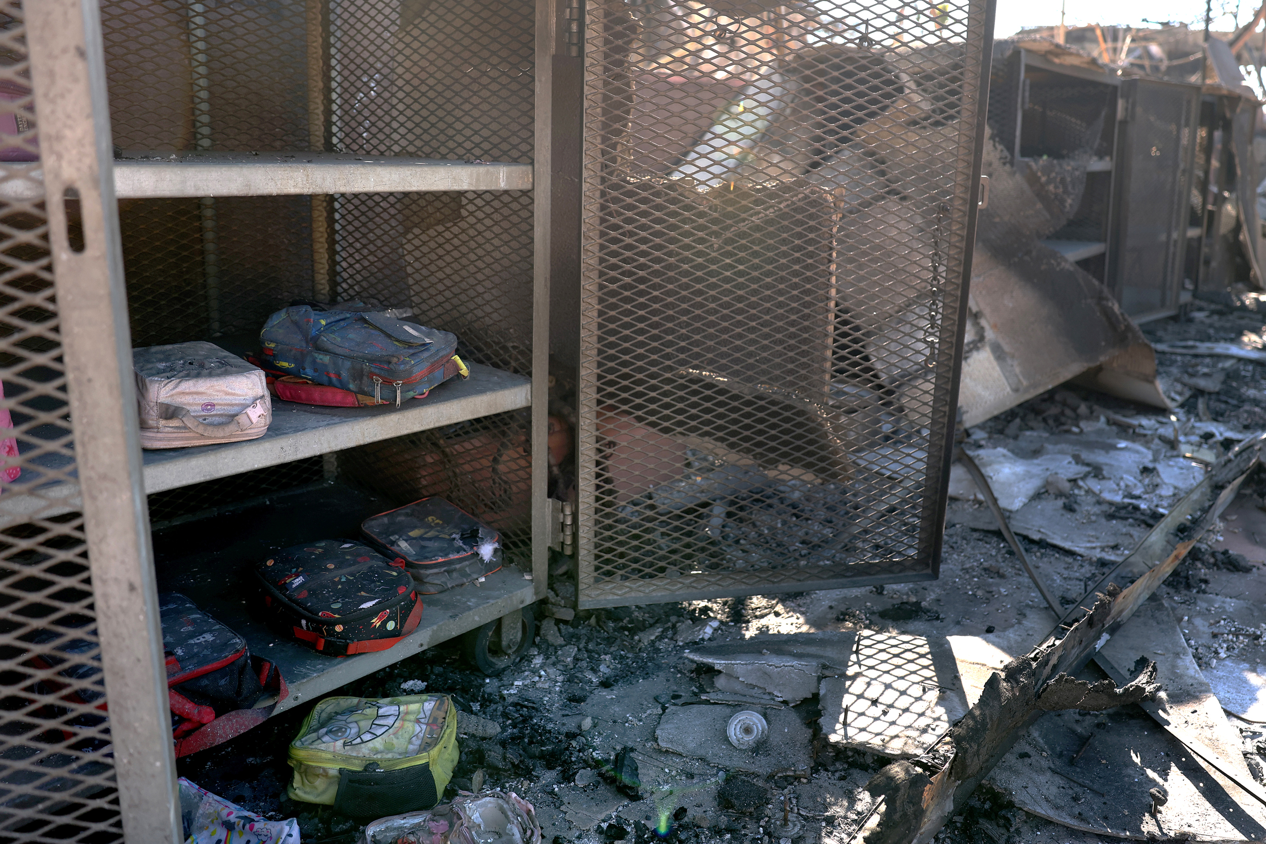 Kids' lunch boxes sit in a locker at the Marquez Charter Elementary School that was destroyed by the Palisades Fire on Jan. 14 in Los Angeles. Credit: Justin Sullivan/Getty Images