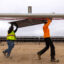 Workers install solar panels for the Los Angeles Department of Water and Power’s solar and battery storage plant in the Mojave Desert of Kern County on Nov. 25, 2024. Credit: Brian van der Brug/Los Angeles Times via Getty Images
