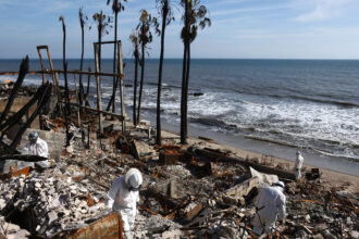 EPA contractors work to remove hazardous waste from beachfront properties destroyed in the Palisades Fire along the Pacific Ocean on Feb. 18 in Malibu, Calif. Credit: Mario Tama/Getty Images