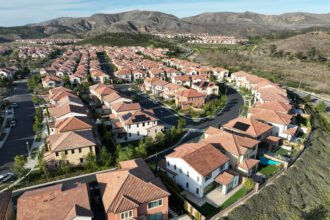 An aerial view of Orchard Hills in Irvine, Calif., where homes have been built to be fire-resistant. The neighborhood handled a fire very well in 2020 due to home construction, community planning, and partnership with the city. Credit: Allen J. Schaben/Los Angeles Times via Getty Images