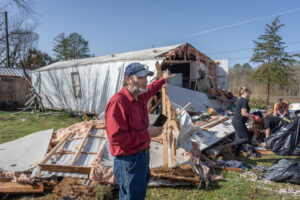 Volunteers help Tim Striegel clean up after his mobile home was hit by a tornado on March 16 in Calera, Ala. Credit: Jan Sonnenmair/Getty Images