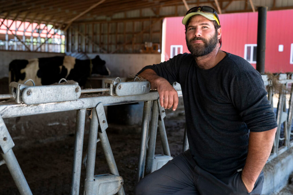 Thomas Prohl, the Senior Manager of Farm Operations at Wolfe’s Neck Center, poses for a photo in the farm’s cow barn on September 17, 2024. 