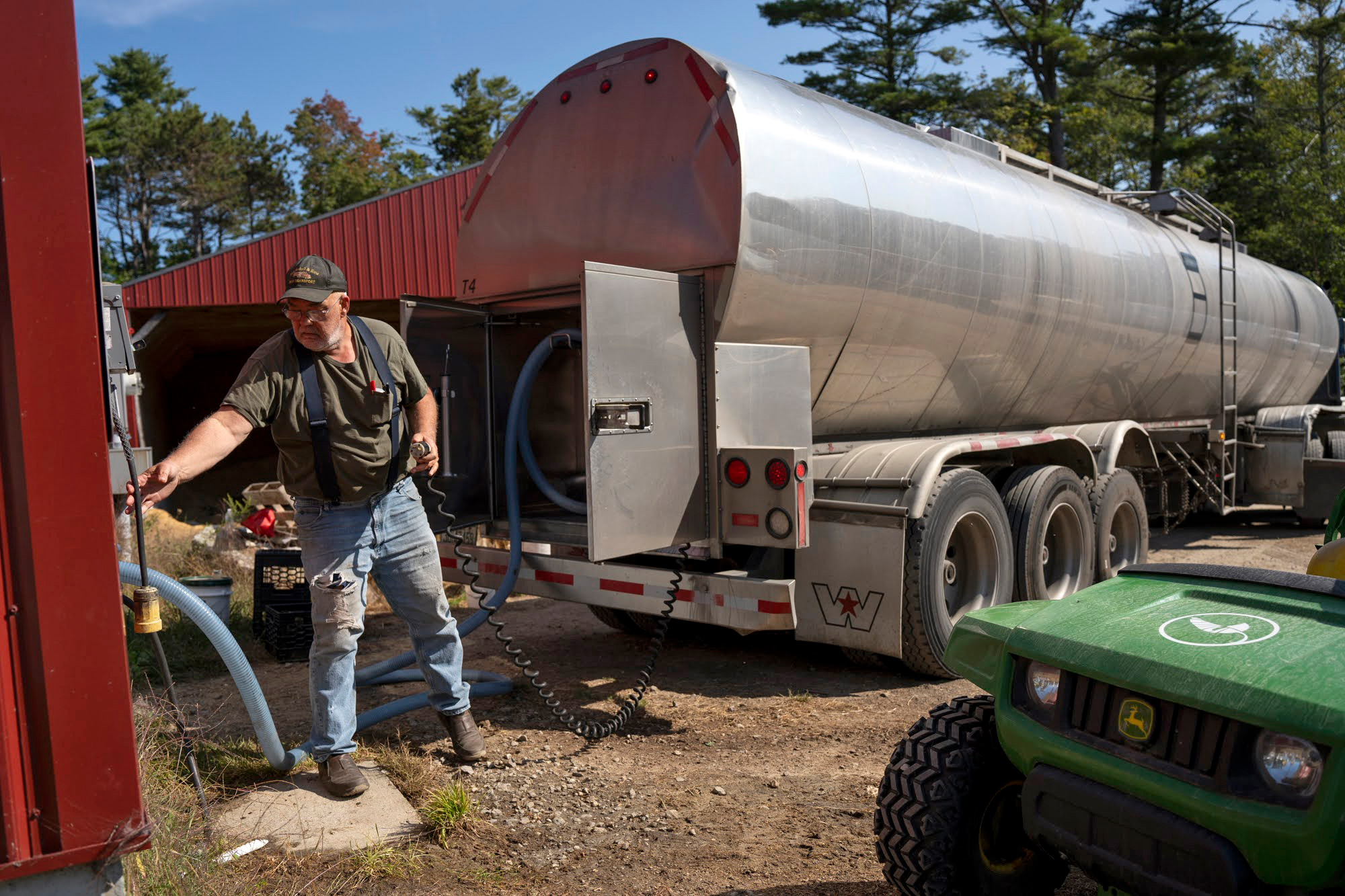 A milk hauler from Stonyfield Organic hooks up his tank to the power supply at Wolfe’s Neck Center on Sept. 17, 2024.