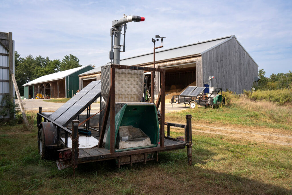 Two ‘Green Feed Systems’ sit at the edge of a field at the New Hampshire University dairy farm.