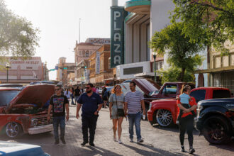 People stroll down Hidalgo Street to take a look at classic cars during the third annual Estos Vatos BorderTown Getdown car show in downtown Laredo on Saturday evening, March 22, 2025. Credit: Sam Owens/San Antonio Express-News