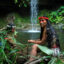 Silvana Nihua, a member of the Kiwaro community and former OWAP president, sits near a sacred waterfall in a Waorani community's territory, Pastaza, Ecuadorian Amazon. Credit: Nico Kingman/Amazon Frontlines