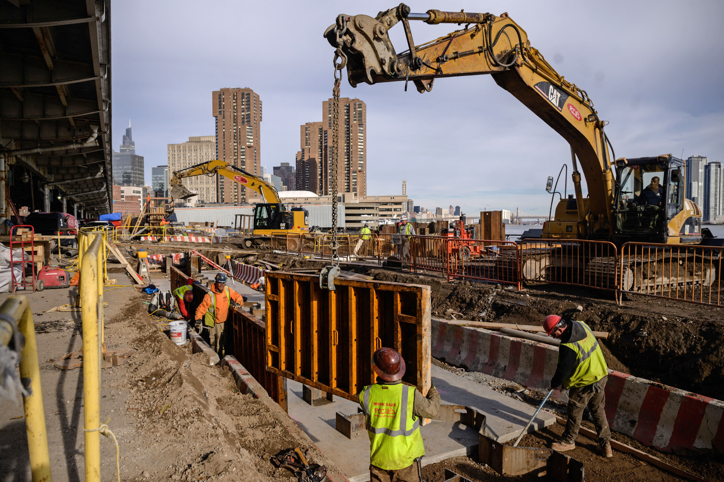 A contruction crew works at the site of a flood defense project on the east side of Manhattan in New York City on Dec. 11, 2021. Credit: Ed Jones/AFP via Getty Images