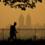 People walk through New York City’s Central Park as smoke from wildfires in Canada cause unhealthy air quality on June 7, 2023. Credit: Timothy A. Clary/AFP via Getty Images
