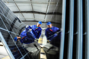 A worker checks solar panels before packaging at a production facility in the Gansu province of China on April 16, 2024. Credit: CFOTO/Future Publishing via Getty Images