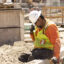 A worker adjusts his helmet on a construction site under the sun in Los Angeles as southern California faces a heatwave on July 3, 2024. Credit: Etienne Laurent/AFP via Getty Images
