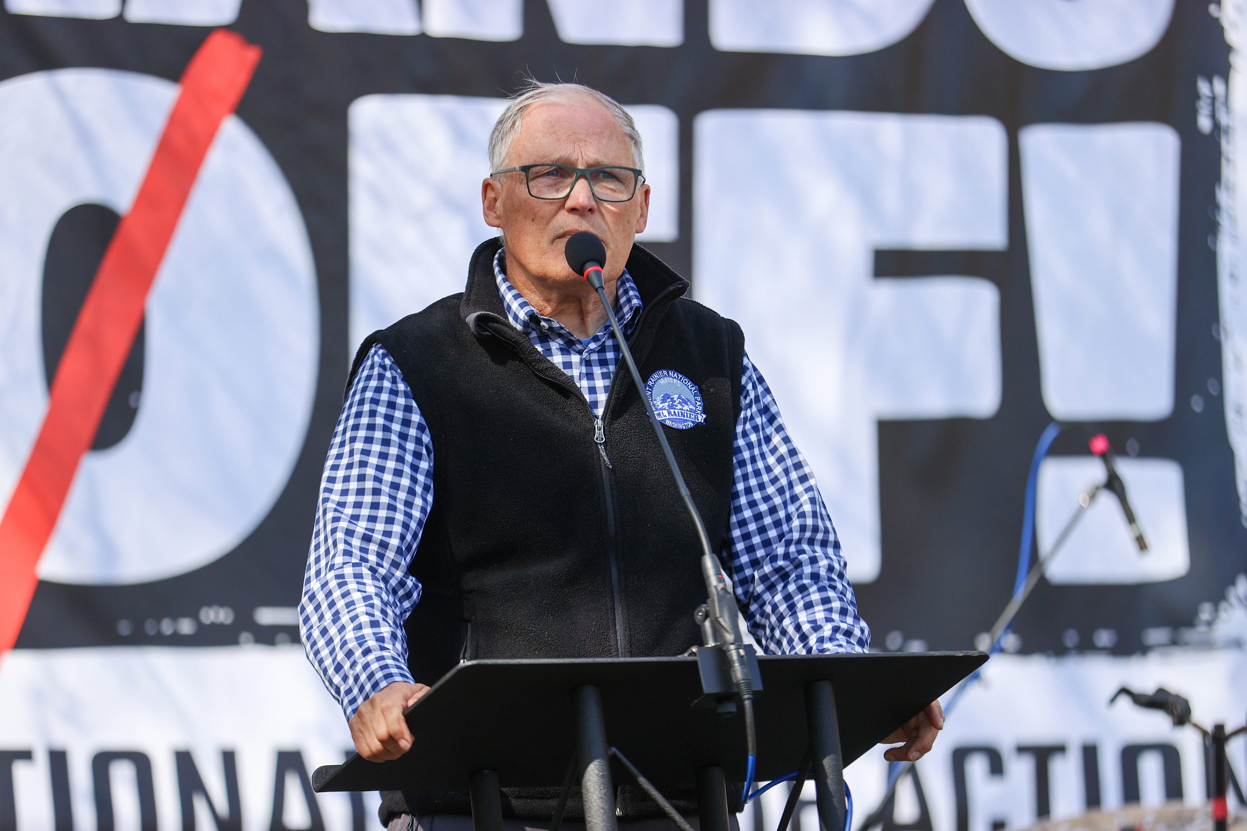 Former Washington Gov. Jay Inslee speaks during the nationwide “Hands Off” protest against President Donald Trump at the Seattle Center on April 5. Credit: Mat Hayward/Getty Images for for Community Change Action