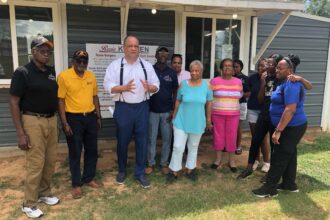 Sierra Club Executive Director Ben Jealous (center, in white) poses with Dr. Robert Bullard (to his left, in yellow), Pastor Timothy Williams and other members of the Shiloh community in south Alabama. Credit: Courtesy of Living on Earth