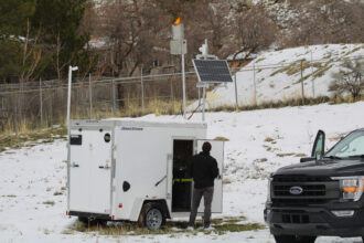 A technician with North American Weather Consultants works on a cloud seeding generator in Ogden, Utah on March 20. Utah has the nation's largest program, and nearby states are watching to see how it adds to the water supply. Credit: Alex Hager/KUNC