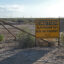 A sign warns of dangerous hydrogen sulfide gas at a drilling site in the Permian Basin in August 2023. Exposure to high concentrations of the gas can be lethal. Credit: Martha Pskowski/Inside Climate News