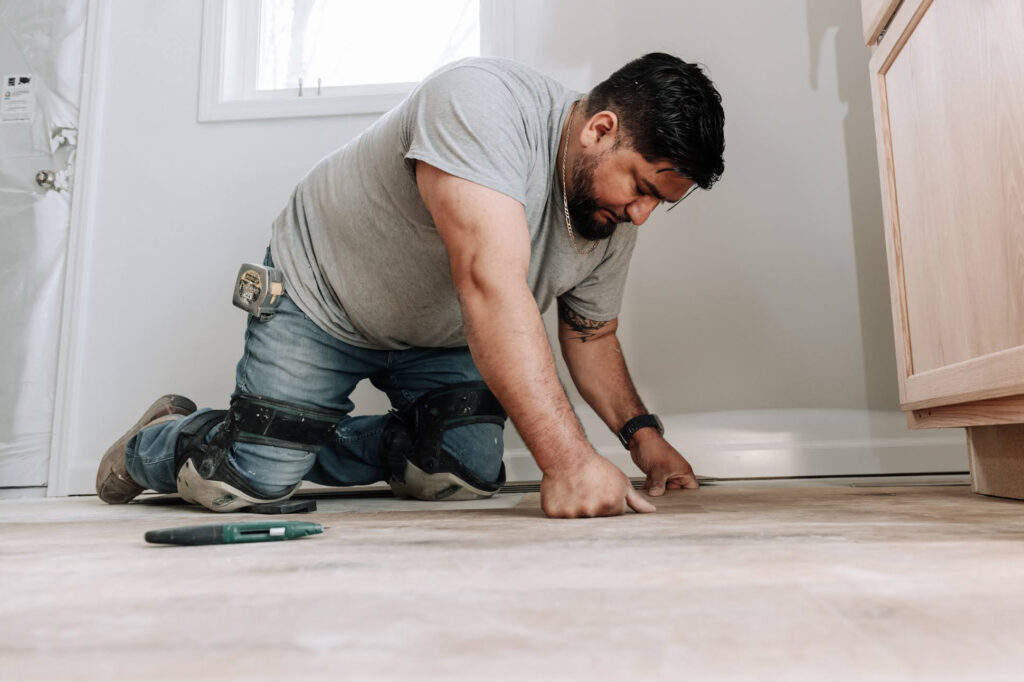 David de Leon paints as part of a house rehabilitation project on March 27 in Fort Wayne, Ind. Credit: Rachel Von Art/Inside Climate News