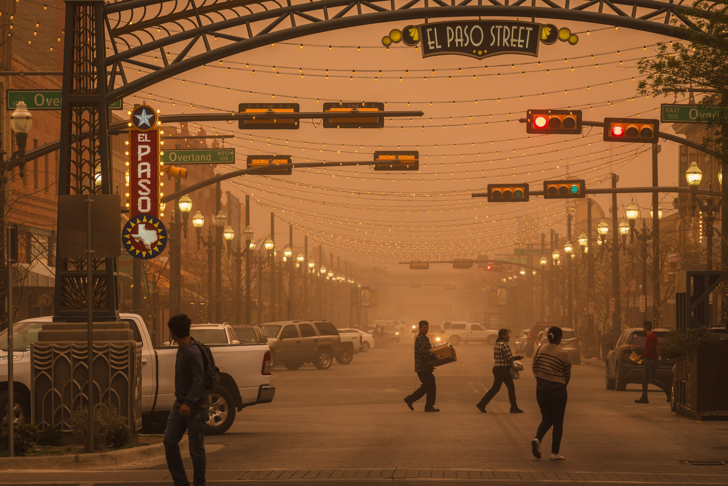 People cross the street during a dust storm on March 7 in downtown El Paso, Texas. Credit: Justin Hamel