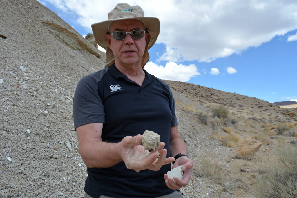 Bernard Rowe, Ioneer’s managing director, holds a piece of clay filled with lithium near the site of the Rhyolite Ridge Mine. Credit: Wyatt Myskow/Inside Climate News