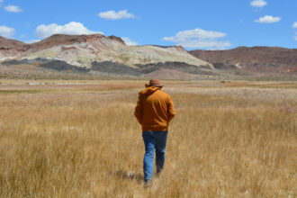 Patrick Donnelly, the Great Basin director for the Center for Biological Diversity, walks through an alkaline meadow in Fish Lake Valley on May 6. The valley used to be home to a series of streams and lakes that once provided habitat for fish like the Fish Lake Valley tui chub. Credit: Wyatt Myskow/Inside Climate News