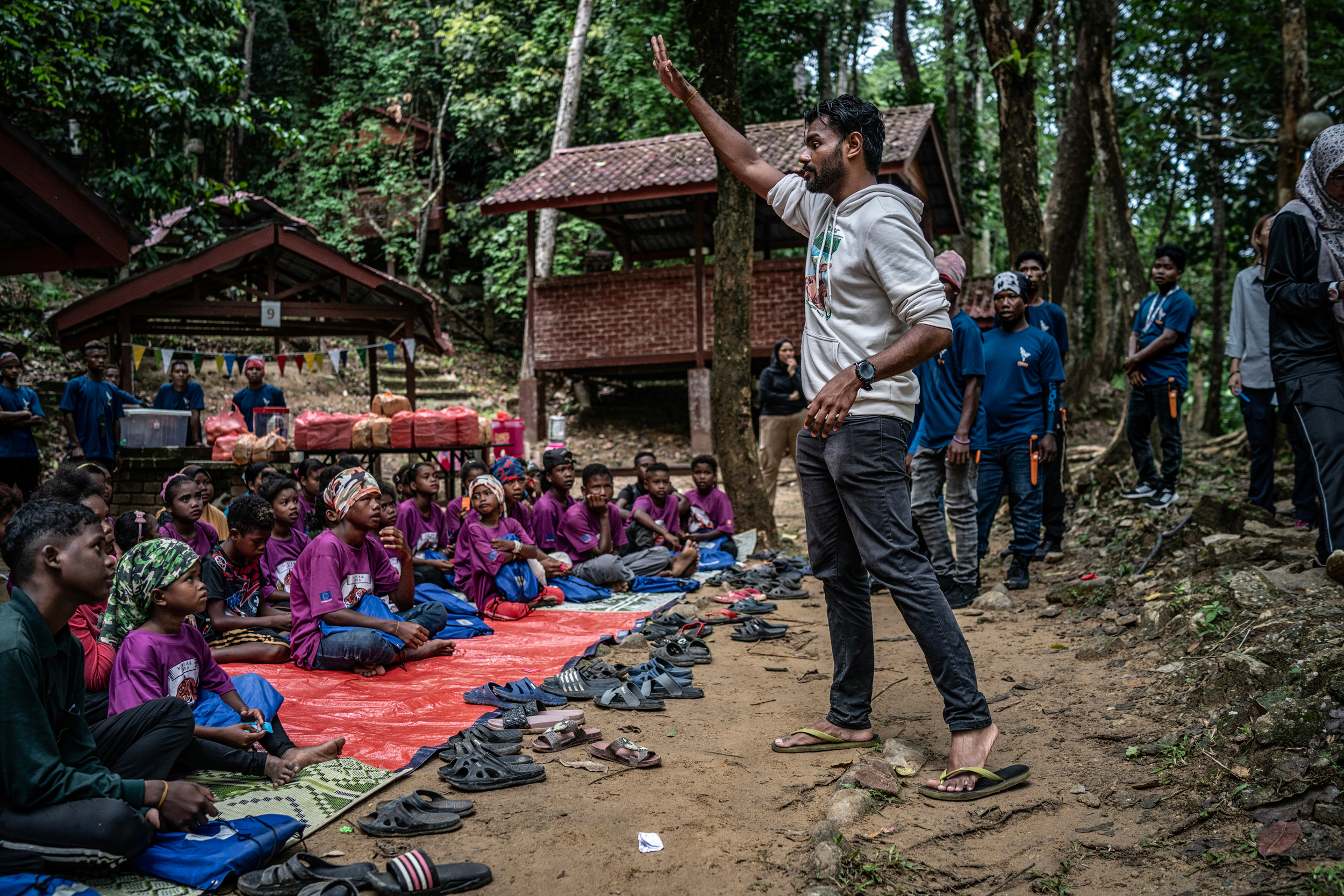 Shawn Stanly Anthony Dass, who is a teacher at a school in the Amanjaya Forest Reserve area, works with children as part of the Menraq Muda (youth program).