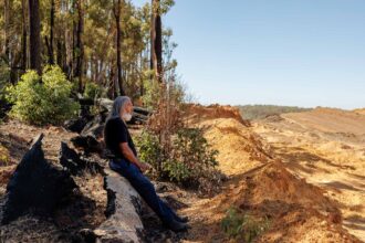 George Walley, a Noongar elder, sits at the edge of an Alcoa mine site near Jarrahdale in Western Australia on March 24. Credit: Quinn Glabicki/PublicSource