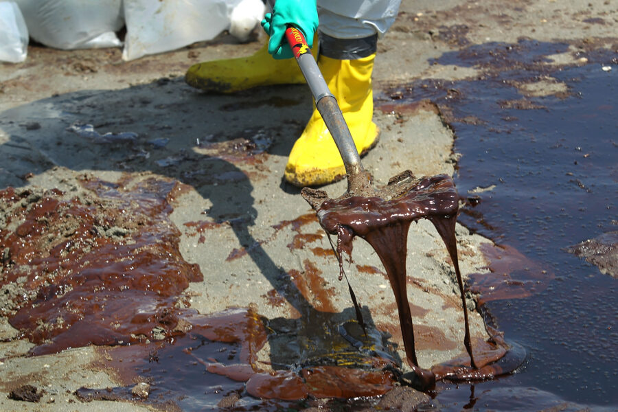 A BP cleanup crew shovels oil from a beach on May 24, 2010 at Port Fourchon, La. Credit: John Moore/Getty Images