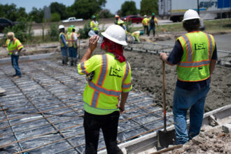 A construction worker takes a sip of water during a heat wave while repairing a road that was damaged from the heat in Houston, Texas on June 27, 2023. Credit: Mark Felix/AFP via Getty Images