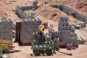 Construction workers build a cinder block foundation for a new house on July 2, 2020, in Santa Fe, N.M. Credit: Robert Alexander/Getty Images