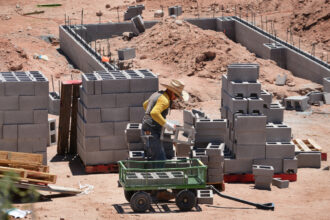 Construction workers build a cinder block foundation for a new house on July 2, 2020, in Santa Fe, N.M. Credit: Robert Alexander/Getty Images