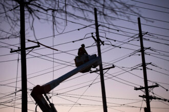Utility workers service a power line in Ridgefield N.J. Credit: EMAZ/VIEWpress via Getty Images