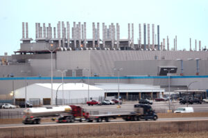 Traffic on Interstate 90 drives by the shuttered Belvidere Assembly Plant in Belvidere, Ill. The United Auto Workers announced in April that Stellantis would not go forward with a battery plant it planned to add to the giant facility. Credit: Photo by Scott Olson/Getty Images