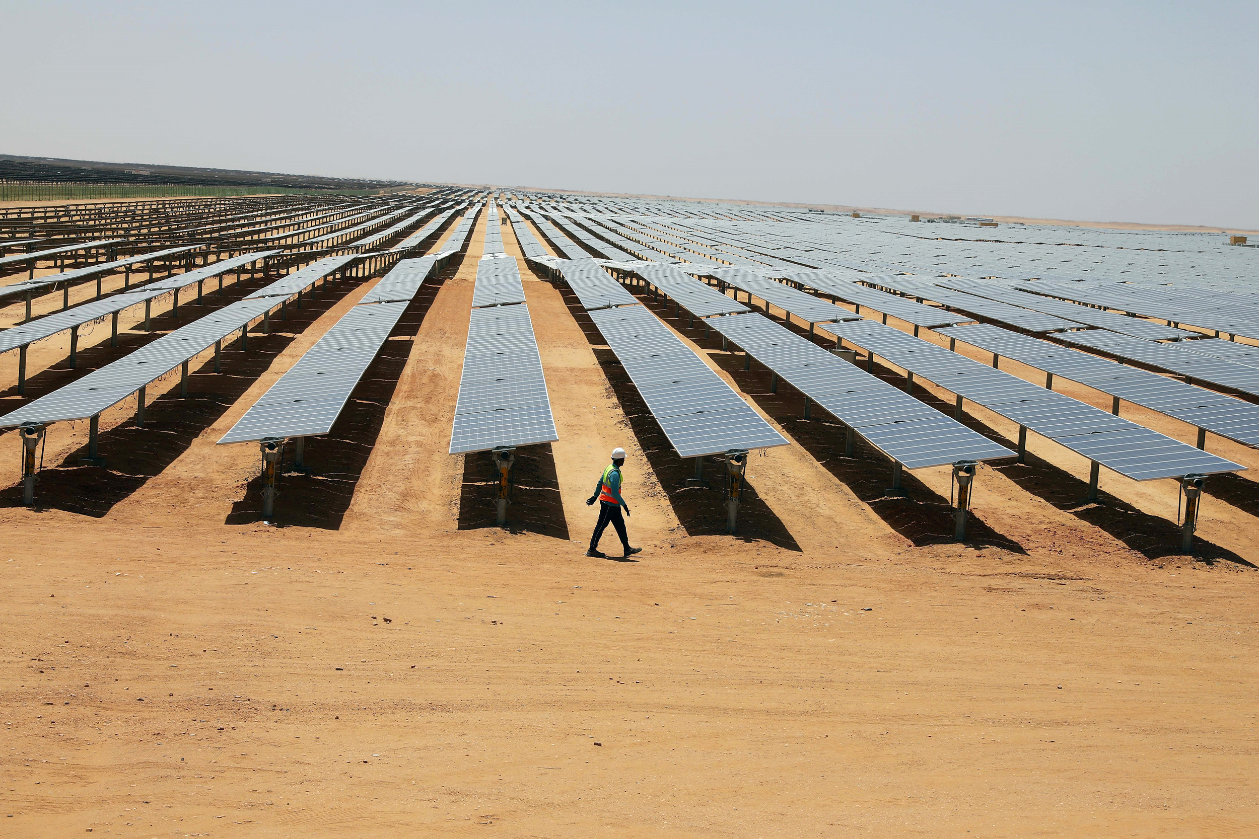 A worker checks solar panels at the Benban Solar Energy Park in Aswan, Egypt, on April 21, 2024. A consortium of Chinese investors helped finance the solar park in 2021 as part of China’s Belt and Road Initiative. Credit: Ahmed Gomaa/Xinhua via Getty Images