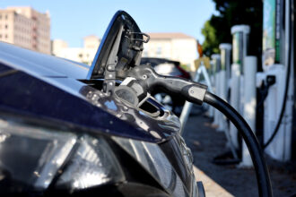 A Nissan Leaf EV charges at station on Sept. 23, 2024 in Pasadena, Calif. Credit: Mario Tama/Getty Images