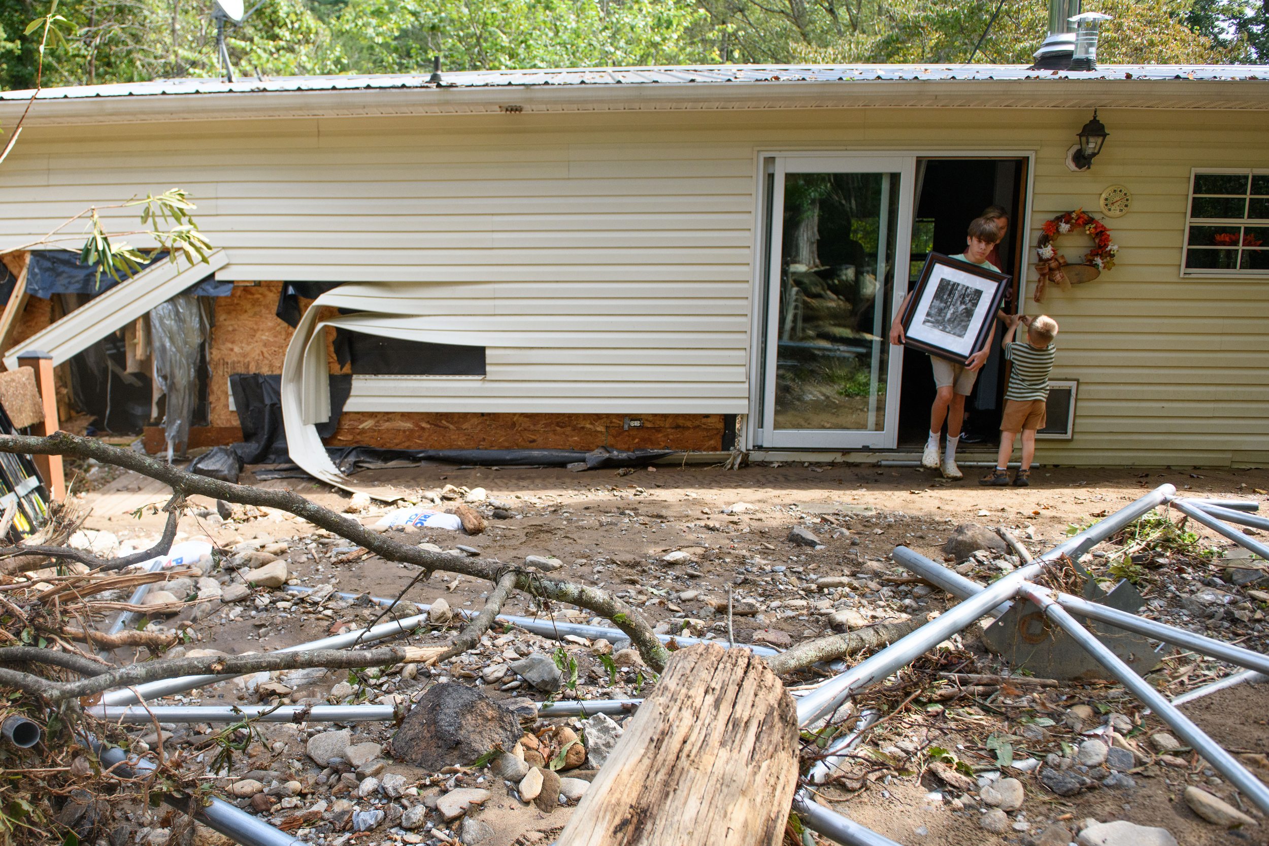 A family salvages belongings in the aftermath of Hurricane Helene on Sept. 30, 2024, in Old Fort, N.C. Credit: Melissa Sue Gerrits/Getty Images