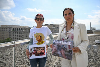 Human rights attorney Alejandra Gonza (right) stands with Brenda Díaz Valencia, who is holding a photo of her father, Antonio Díaz Valencia, and his colleague Ricardo Arturo Lagunes Gasca, in Washington, D.C. on Oct. 3, 2024. The two men disappeared after criticizing mining practices in Mexico. Credit: Richard Pierrin/AFP via Getty Images