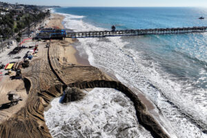 A slurry mix of sand and seawater is pumped onto the main public beach during a sand replenishment project for eroding shoreline related to sea level rise on Nov. 21, 2024 in San Clemente, Calif. Credit: Mario Tama/Getty Images