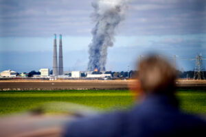 A bystander watches a fire burn at the Vistra Corp. battery storage plant on Jan. 17 in Moss Landing, Calif. Credit: Doug Duran/Digital First Media/East Bay Times via Getty Images