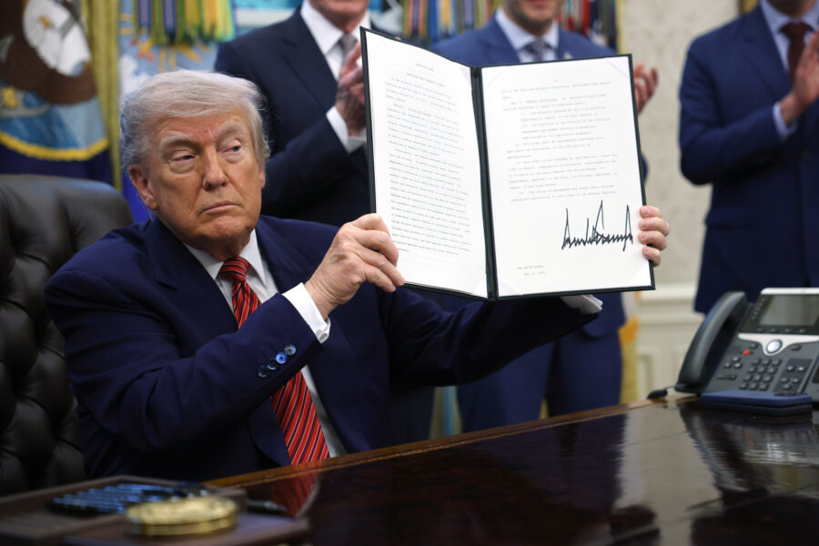 President Donald Trump holds up a signed executive order related to the nuclear power industry in the Oval Office of the White House on Friday. Credit: Win McNamee/Getty Images