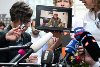 Peruvian farmer Saúl Luciano Lliuya is seen on a laptop during a statement for media on Wednesday after the Higher Regional Court ruling in Hamm, Germany. Credit: Ina Fassbender/AFP via Getty Images