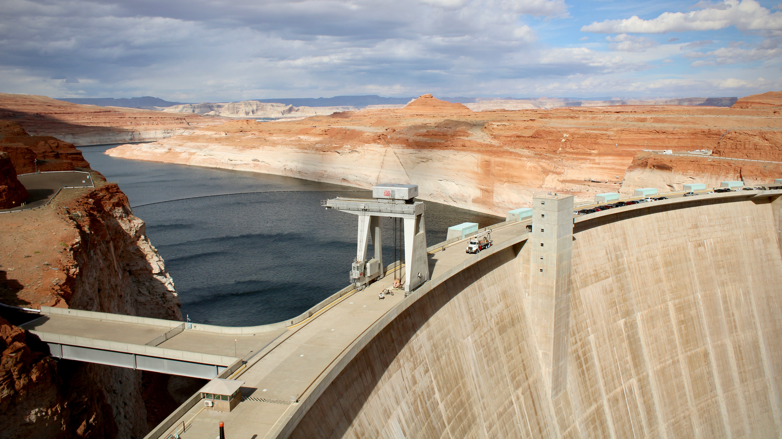 Water sits low behind Glen Canyon Dam on Nov. 2, 2022 near Page, Ariz. Low water levels in Lake Powell could jeopardize the dam's ability to produce hydropower or pass water downstream. Credit: Alex Hager/KUNC