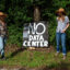 Sisters Abigail and Jennifer Lindsey stand on their rural property on May 27 outside New Braunfels, Texas, where they posted a sign in opposition to a large data center and power plant planned across the street. Credit: Dylan Baddour/Inside Climate News
